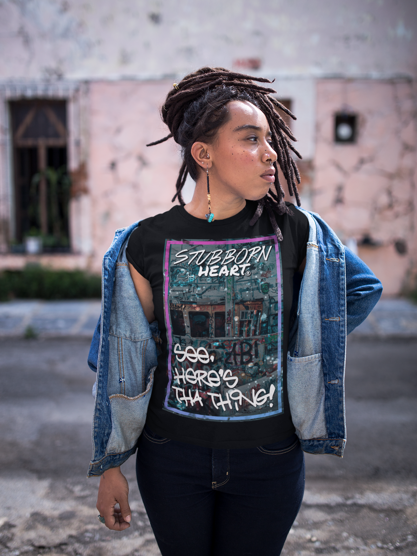 Black female wearing a 'See Here's Tha Thing!' T-Shirt sold by the UK clothing brand STUBBORN HEART