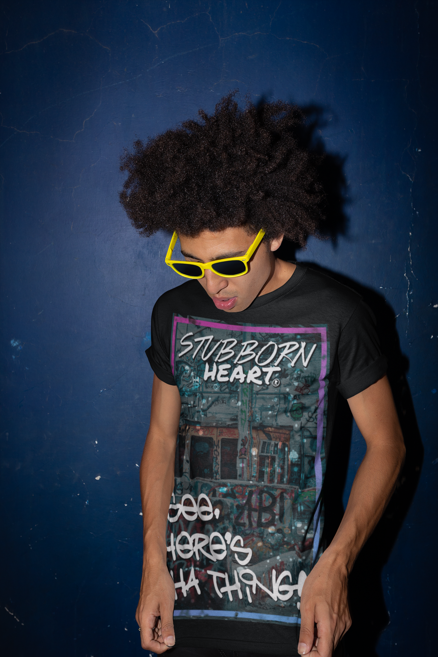 Male model with afro wearing a black version of the STUBBORN HEART designed tee shirt called 'See Here's Tha Thing!