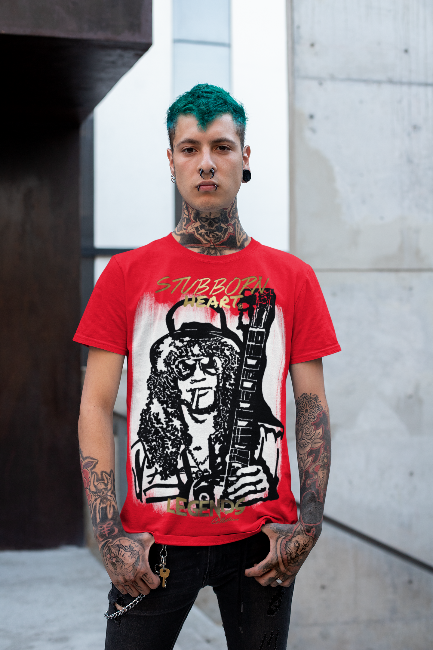 Tattooed male with dyed green hair wearing a Slash guitarist tee from STUBBORN HEART Apparel